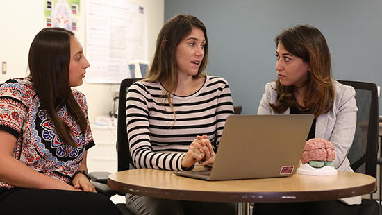 Movement disorder fellows having a discussion.